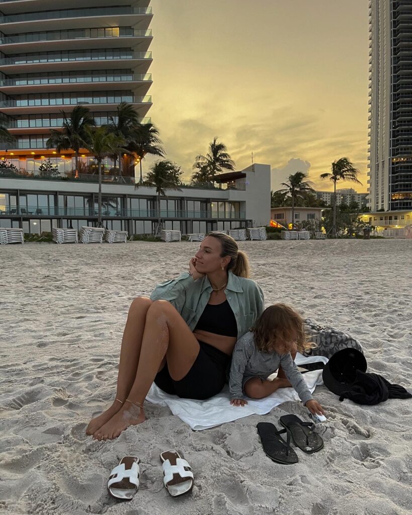 zara poplin shirt, green button down shirt, solid and striped sport, bandier, black bike shorts, solid and striped bike shorts, solid and striped sports bra, family beach photo, miles baby brand, hermes sandals, electric picks jewelry